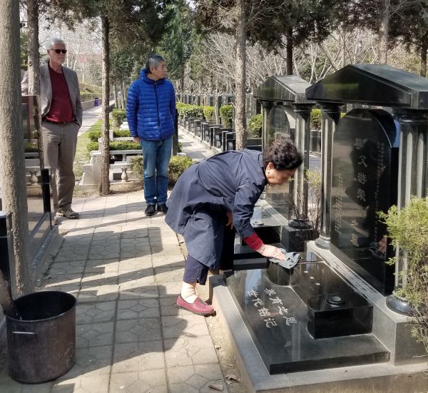 Cleaning the tombstone was a sober group effort